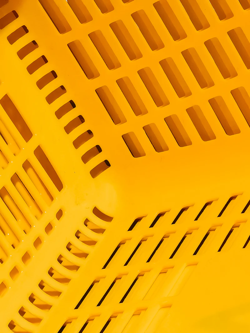 Yellow plastic laundry basket