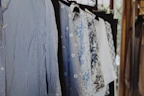 A collection of trendy blouses with varsity-inspired designs displayed on mannequins.