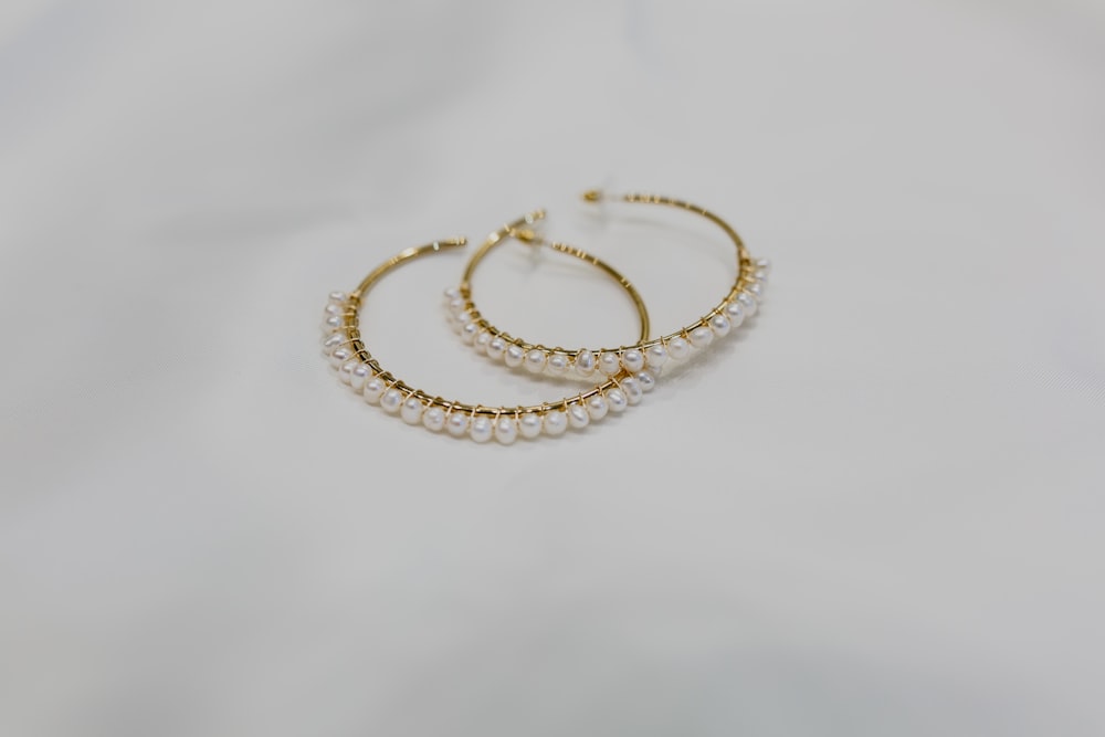 gold bracelet on white textile