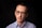 man in blue and white striped dress shirt wearing black framed eyeglasses