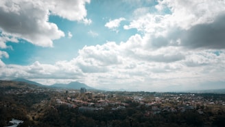 A panoramic view of Huancabamba's lush green hills under a bright blue sky.