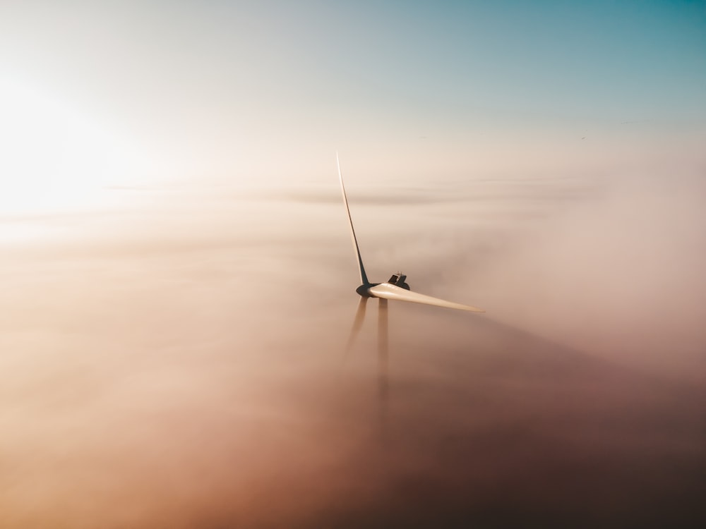 white airplane flying over the sea