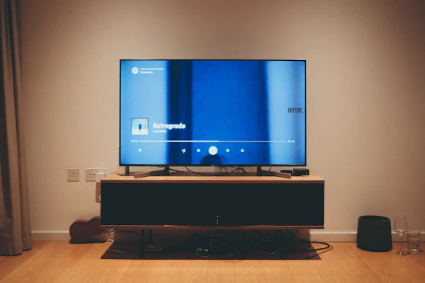 Wall-mounted TV with soundbar and media console