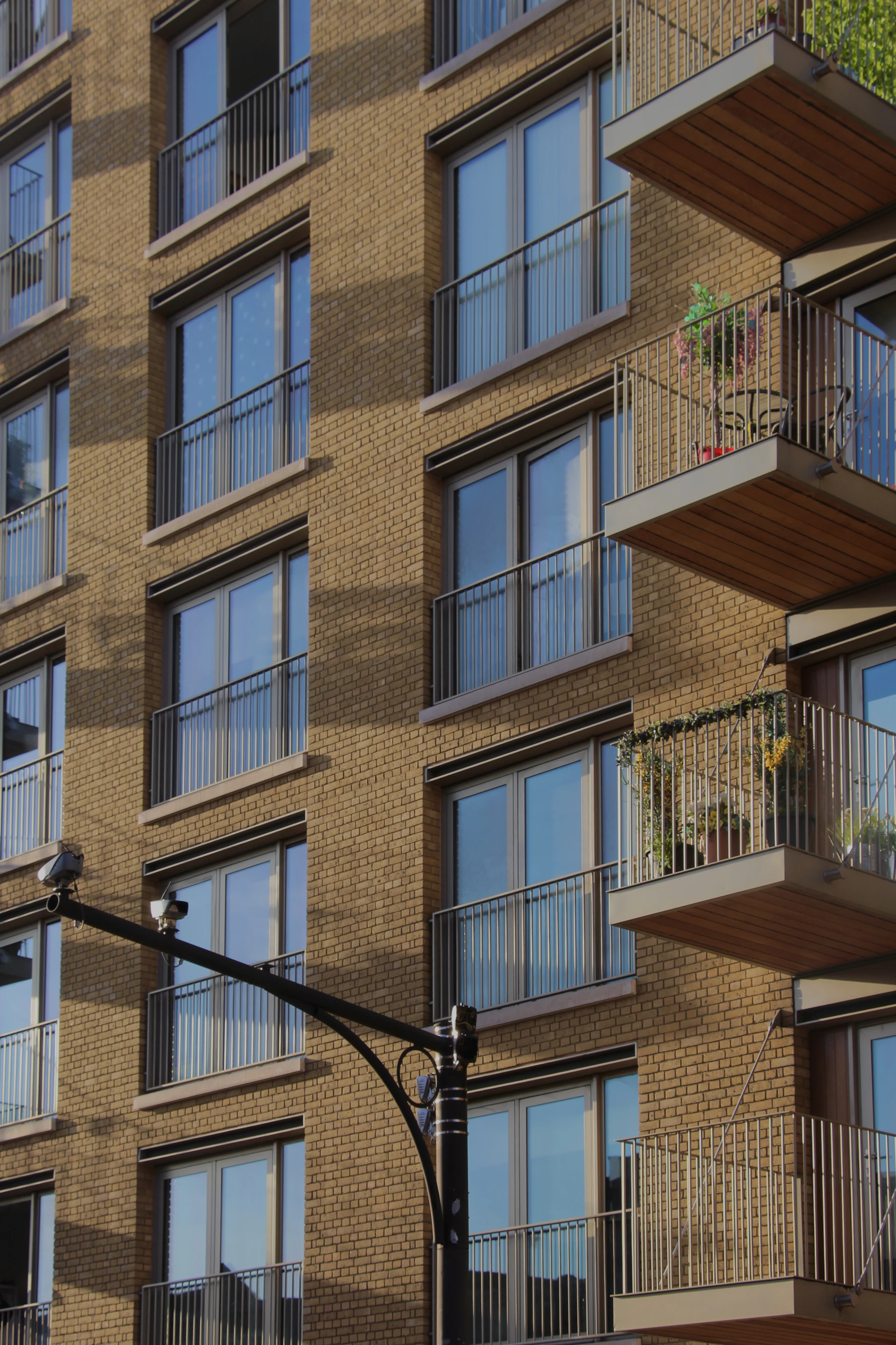 Brown and white urban apartment building with balconies