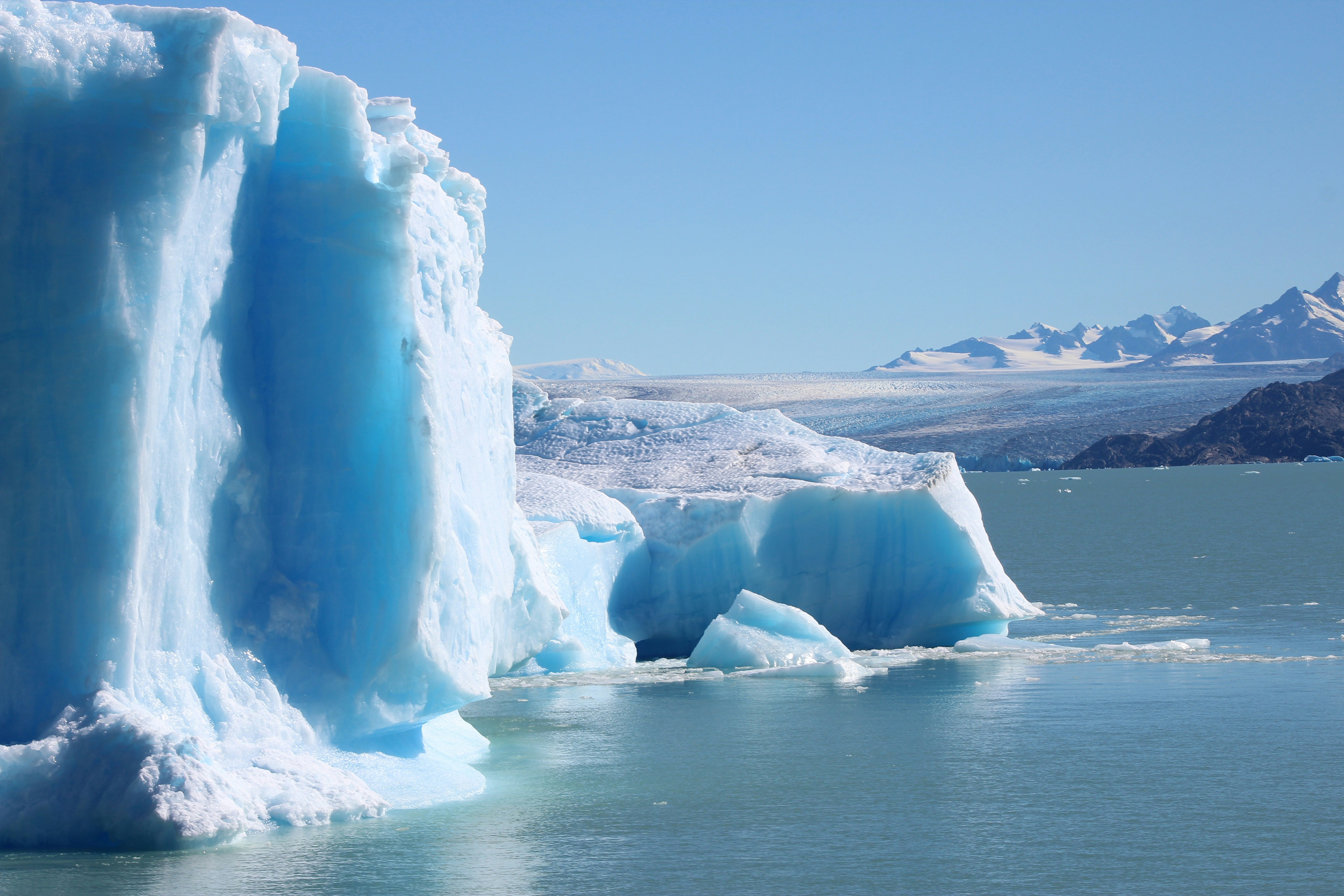 white rock formation on sea water during daytime