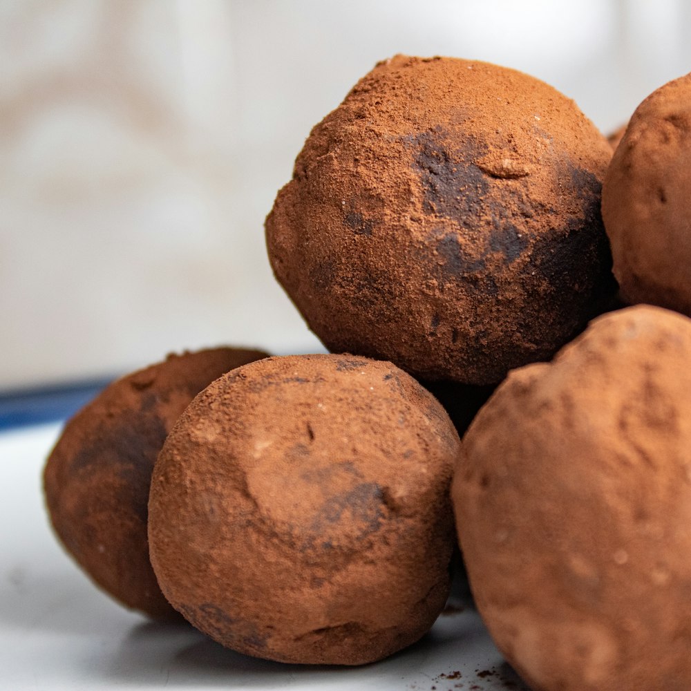 three brown round cookies on white table