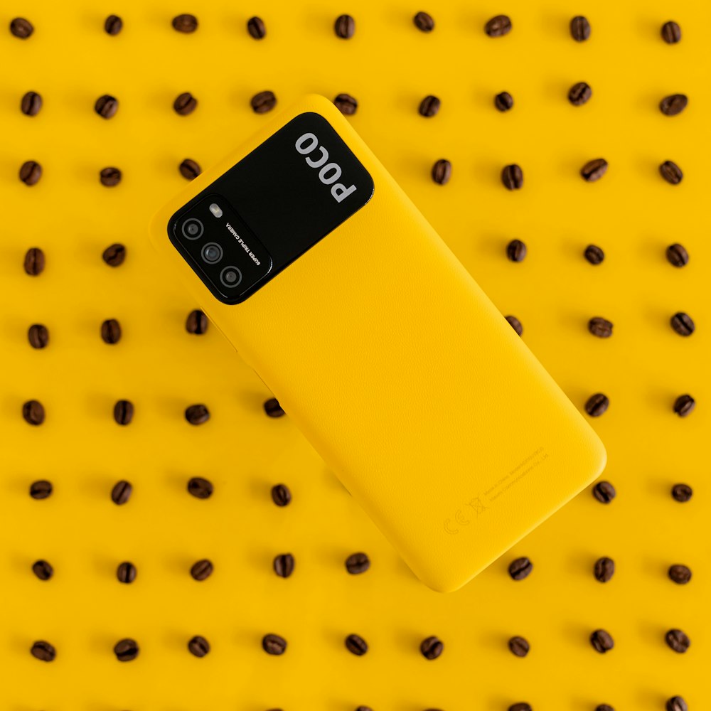 yellow nokia phone on yellow and white polka dot textile
