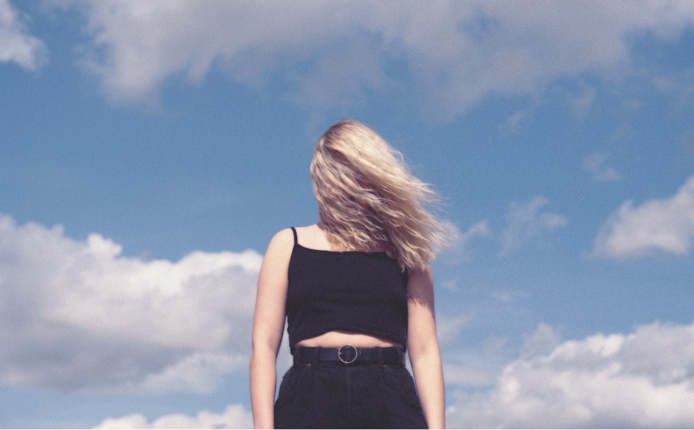 woman in black tank top and black denim bottoms