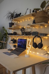 black and gray laptop computer beside black headphones