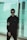 man in black jacket standing near glass wall