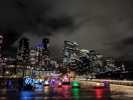 A vibrant cityscape illuminated by LED displays at night.