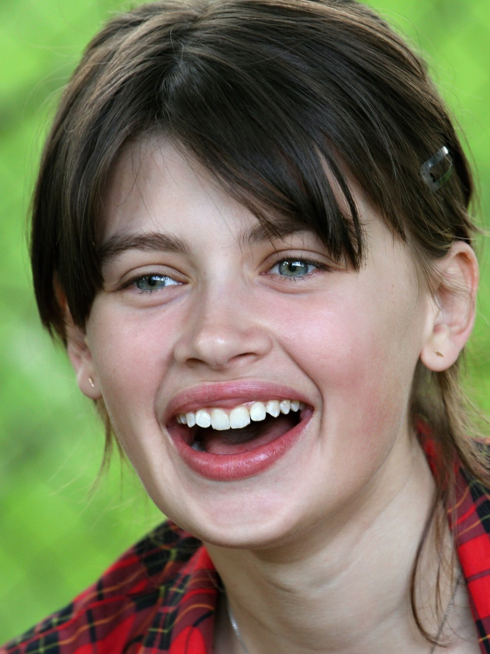 smiling girl in red and black shirt