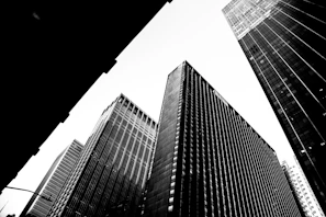 Black and white photo of a city skyline at dusk with sharp contrasts.