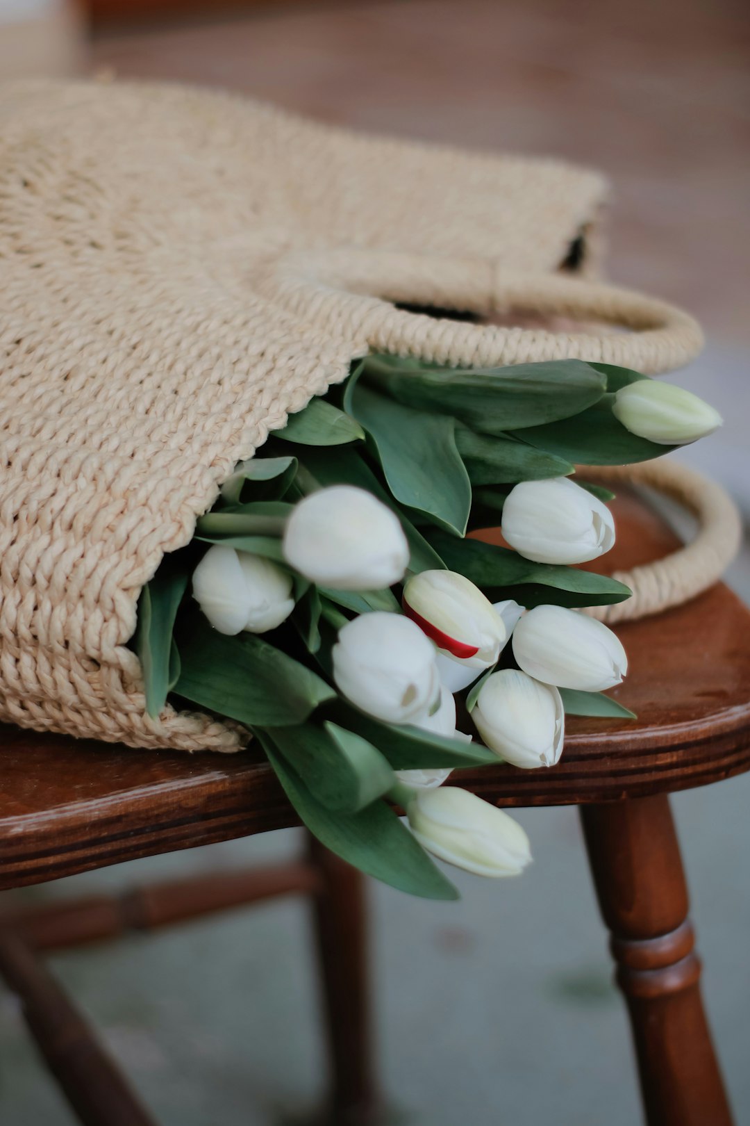 white tulips on brown wooden table