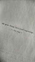 A motivational quote printed in black text on a textured white paper. The quote reads: 'All great things have small beginnings.' The author's name, Peter Senge, is printed below the quote, centered and flanked by horizontal lines.