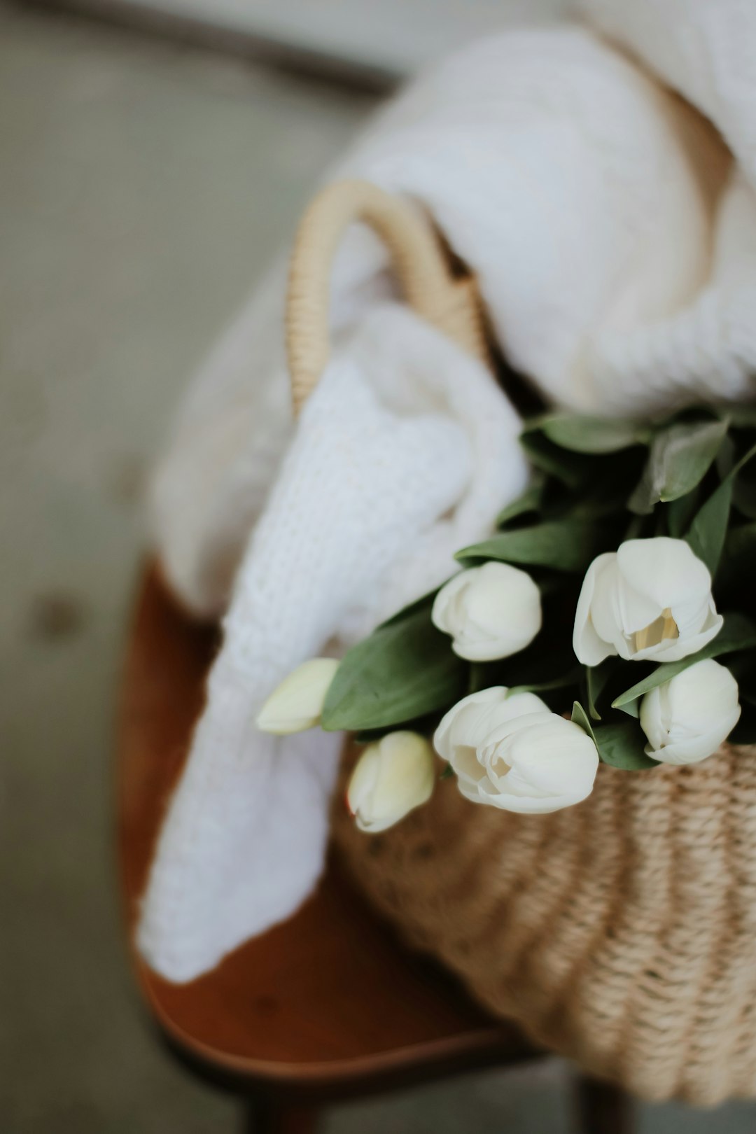 white roses on brown woven basket