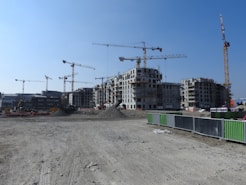 black and yellow crane near building during daytime