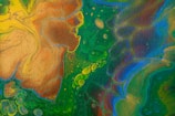 An abstract fluid art painting featuring swirling patterns and shapes with a mix of vibrant colors like green, blue, yellow, and brown. The textures and fluid dynamics create a sense of movement across the canvas, with overlapping layers resembling natural formations or cellular structures.