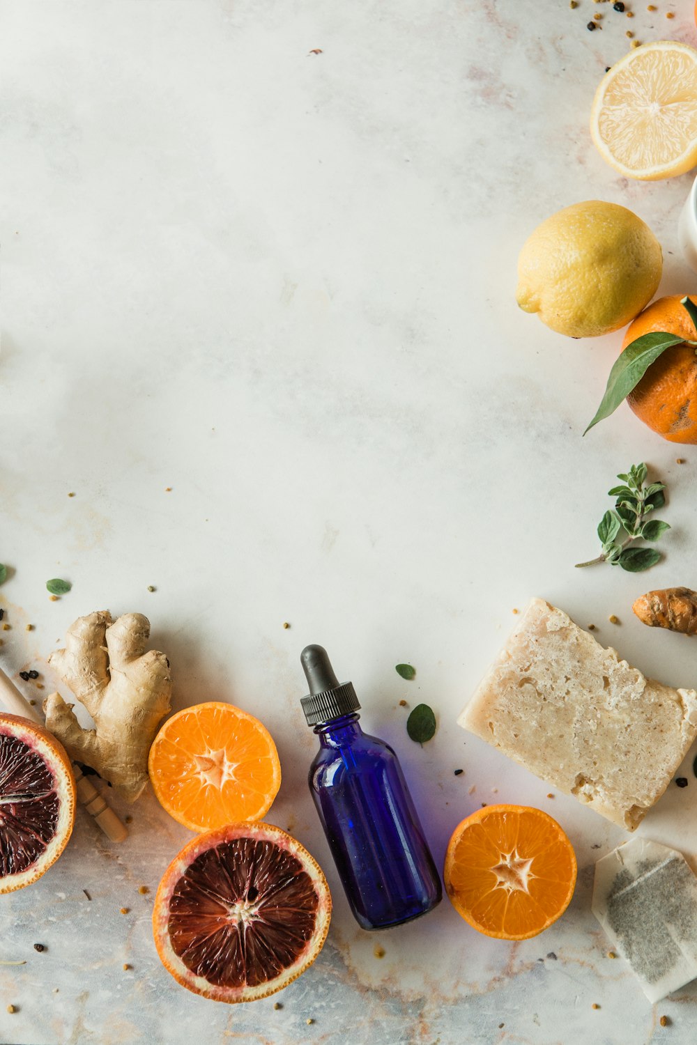 orange fruit beside blue glass bottle