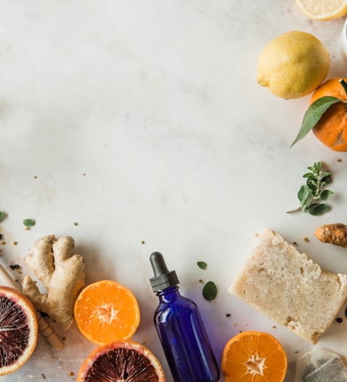 orange fruit beside blue glass bottle