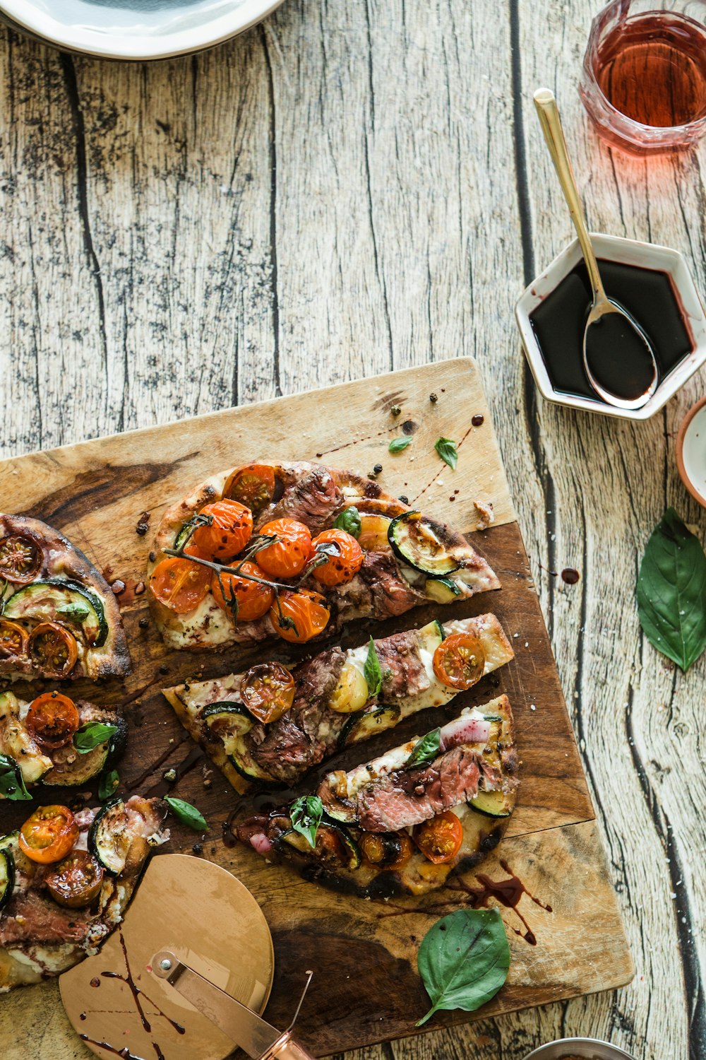 sliced pizza on brown wooden table