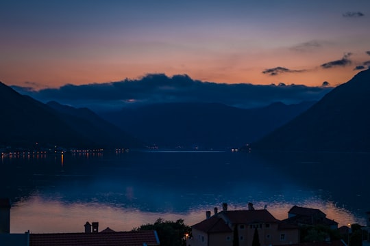 silhouette of mountains near body of water during sunset in Dobrota Montenegro