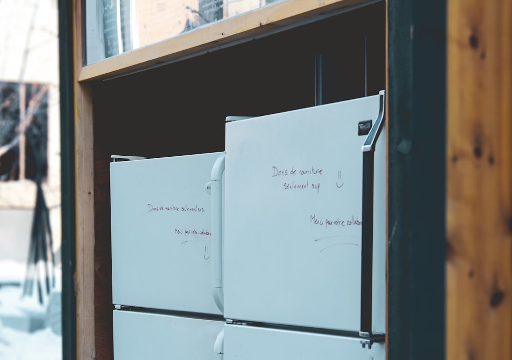 white top mount refrigerator beside brown wooden shelf