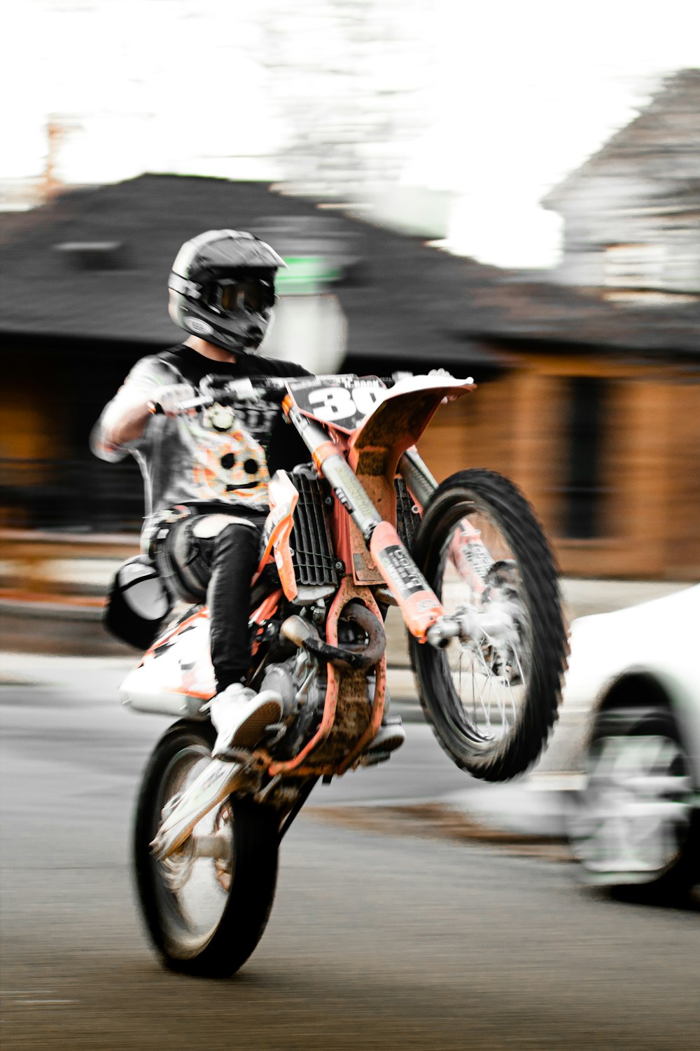 man in black helmet riding orange motorcycle