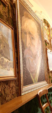 Gallery wall featuring multiple wooden portraits in a modern setting.