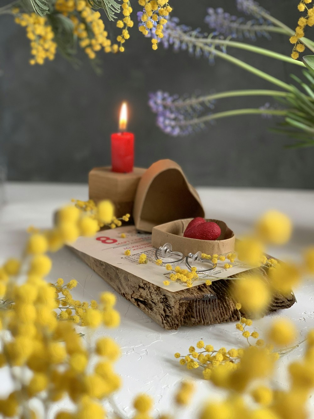 red heart shaped candle on brown wooden tray