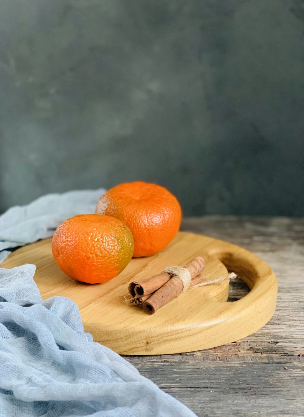 orange fruit on brown wooden chopping board