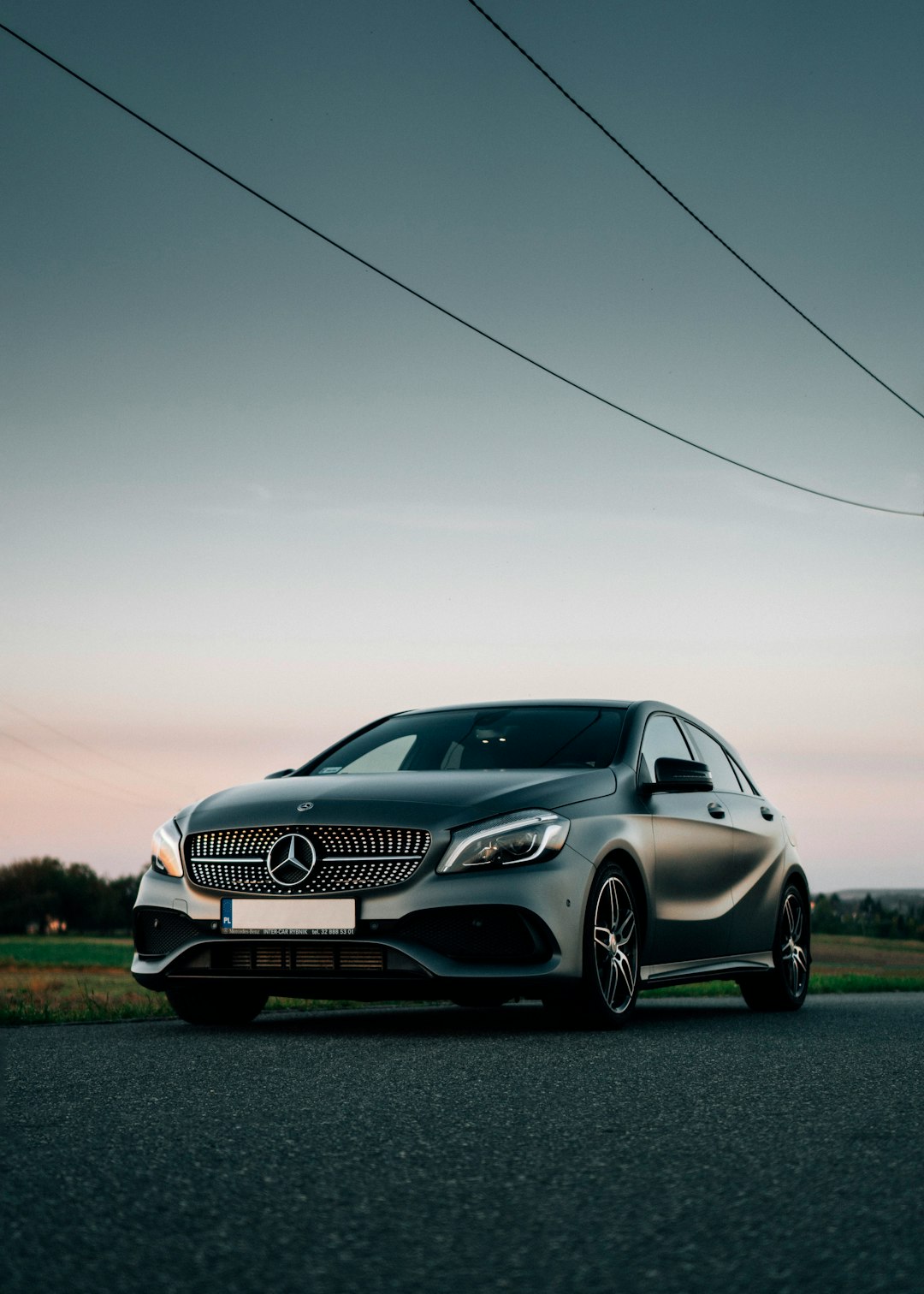 silver mercedes benz coupe on green grass field during daytime