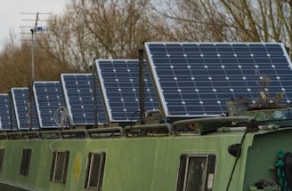 blue solar panels on green and white bus