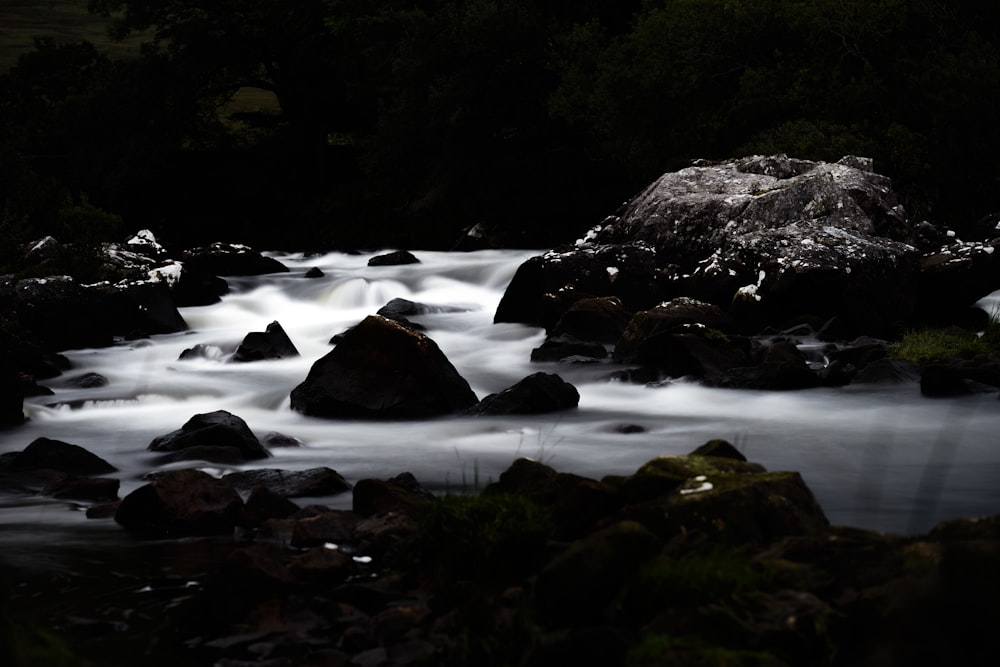 rocky river with rocks on the side