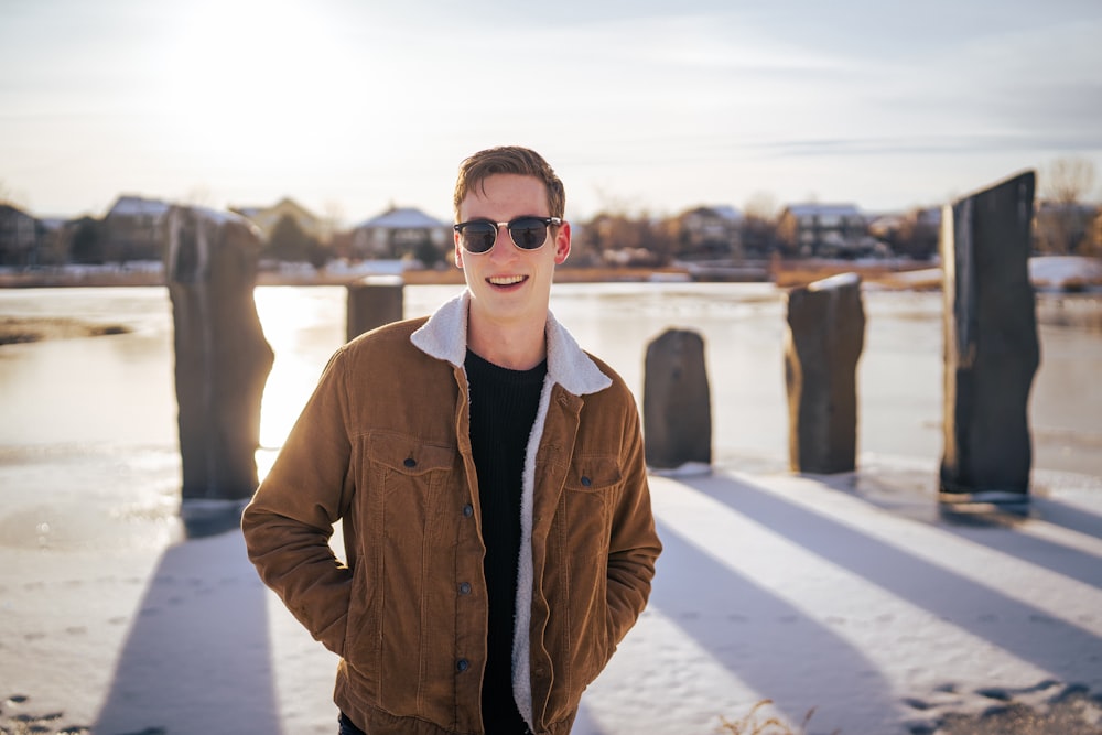 man in brown jacket wearing black sunglasses