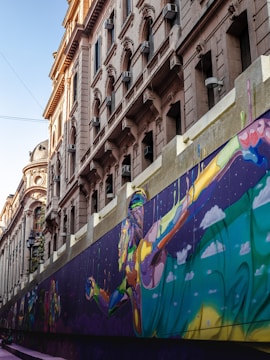 Exterior wall of a city hall featuring a large, futuristic mural with clean lines and bold colors.