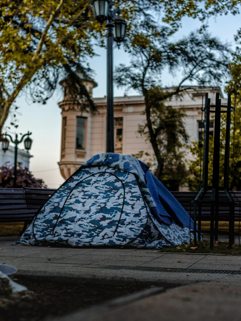 blue and white tent on gray concrete floor during daytime