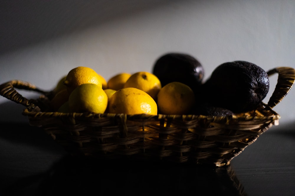 yellow citrus fruits on brown woven basket