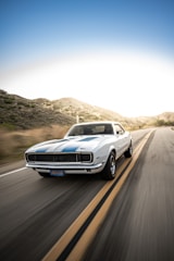 white audi coupe on road during daytime