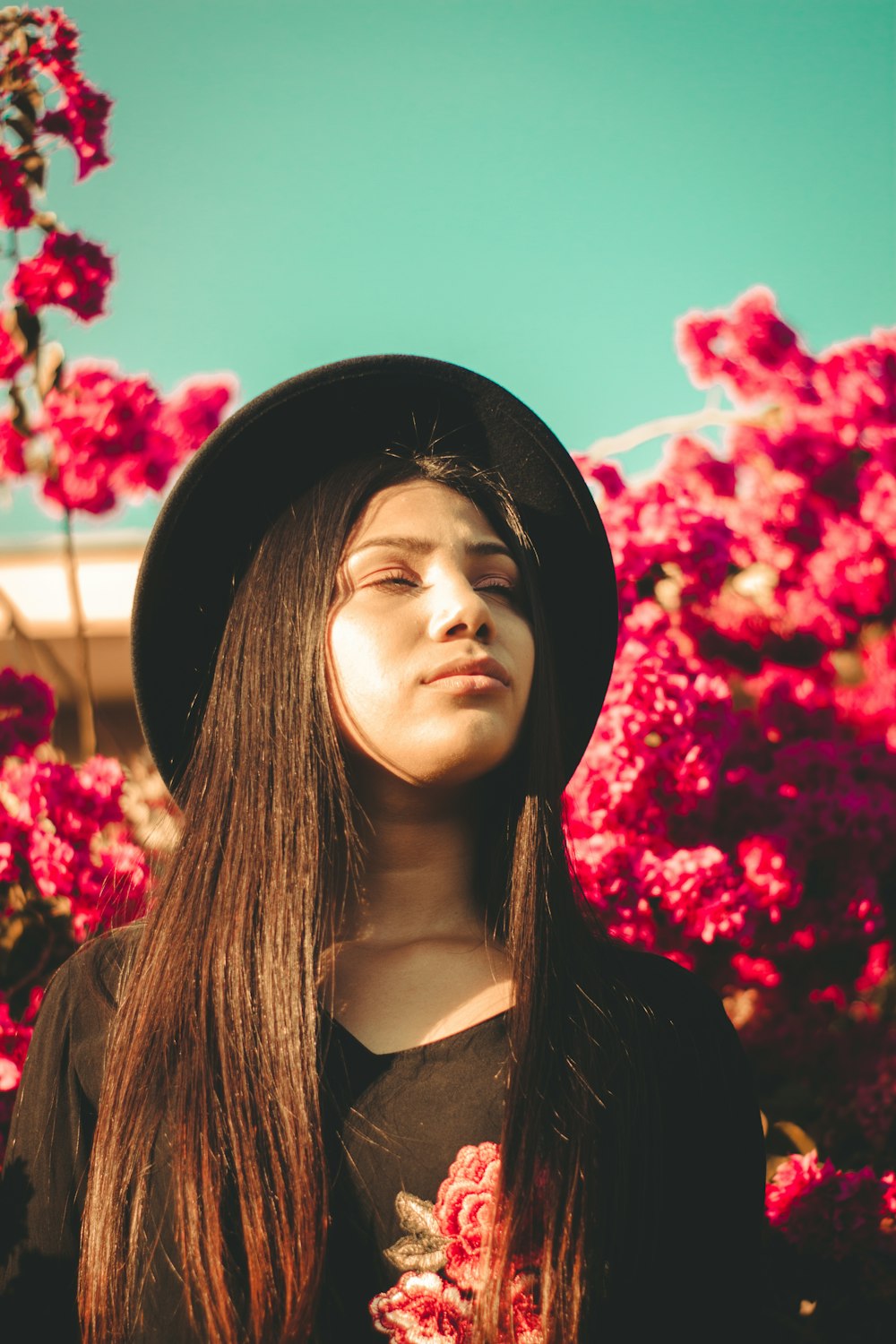 woman in black hat and black jacket