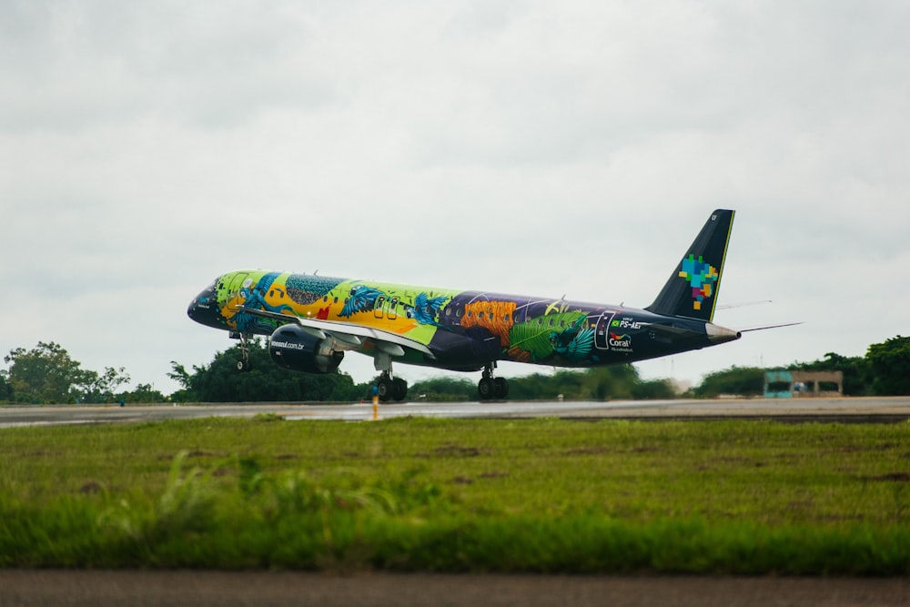 blue and yellow air plane on green grass field under white cloudy sky during daytime