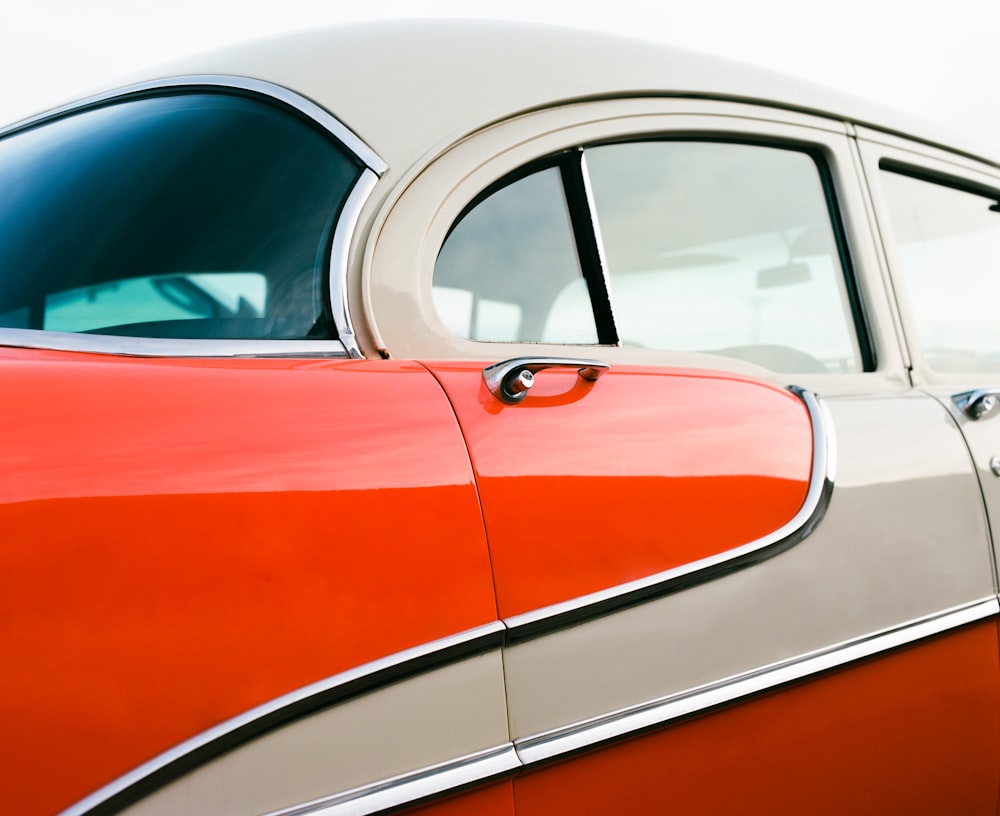 orange and white car in a white room