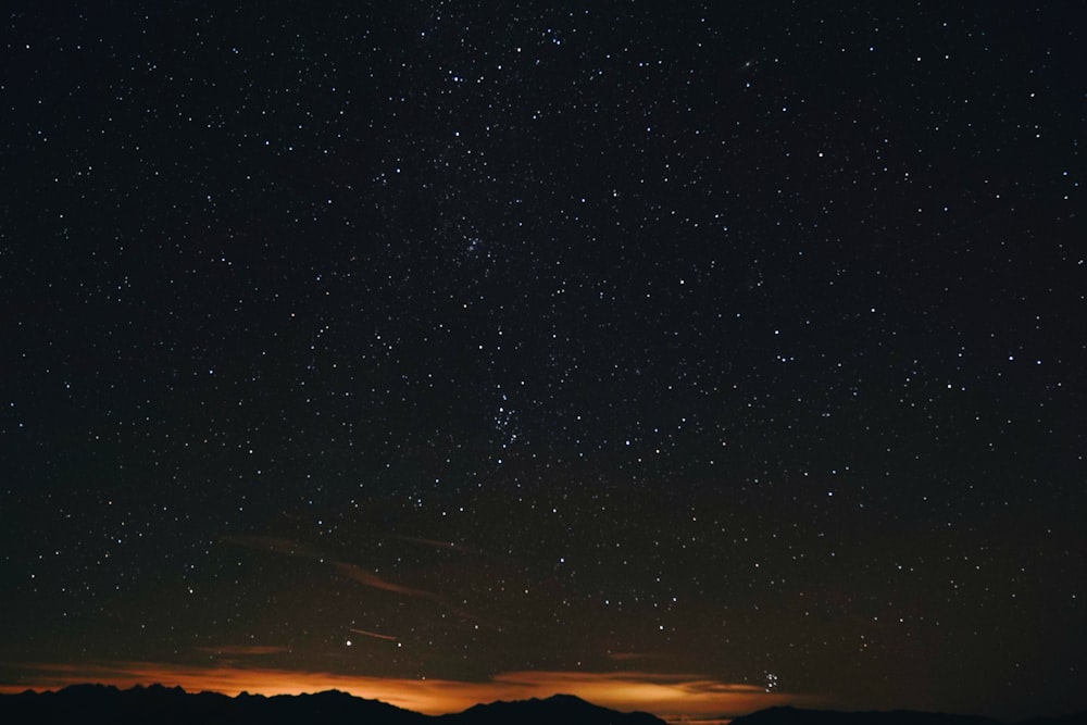 silhouette of mountain during night time