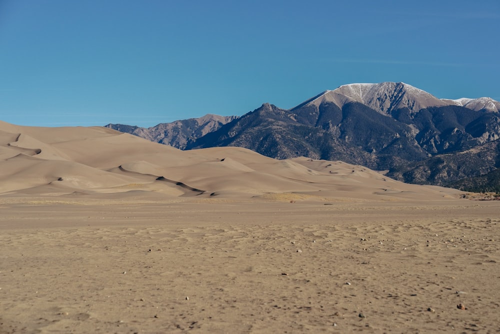 brown sand and mountains during daytime