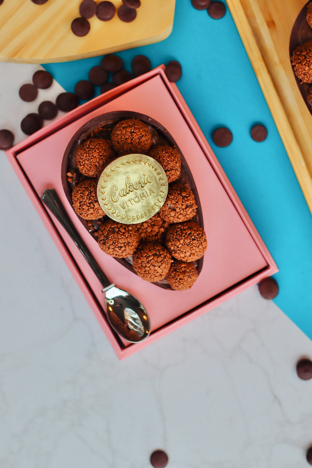 brown and black round coins in red box