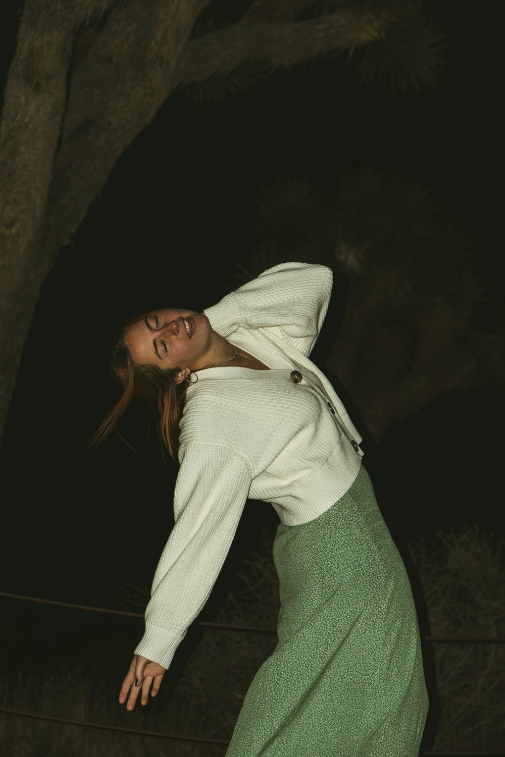 woman in white zip up hoodie and green denim jeans