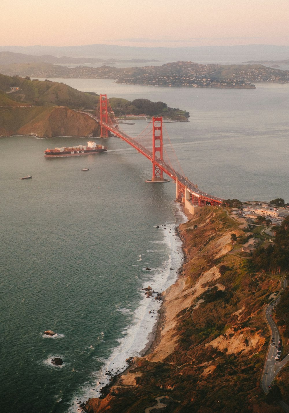 red bridge over the sea during daytime