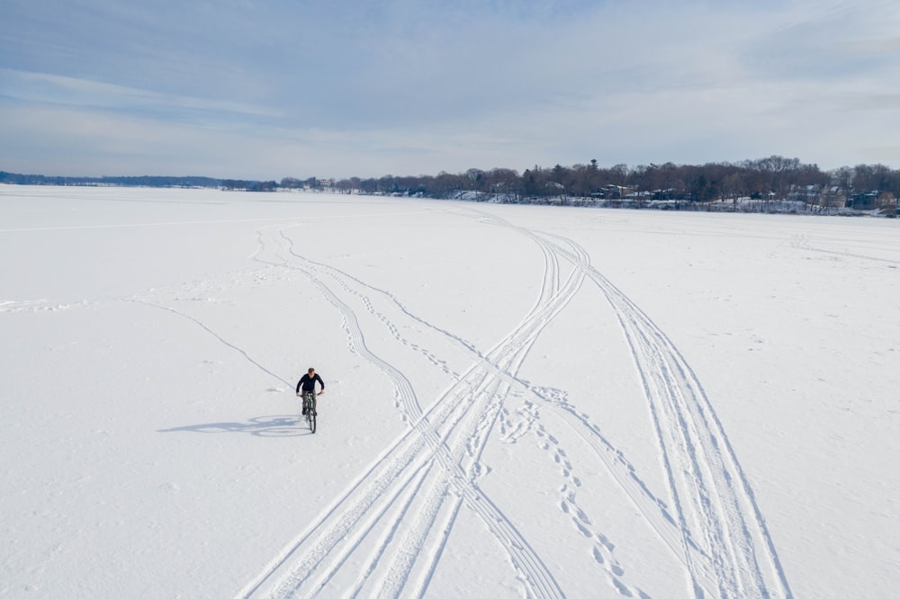 2 person riding ski blades on snow covered ground during daytime