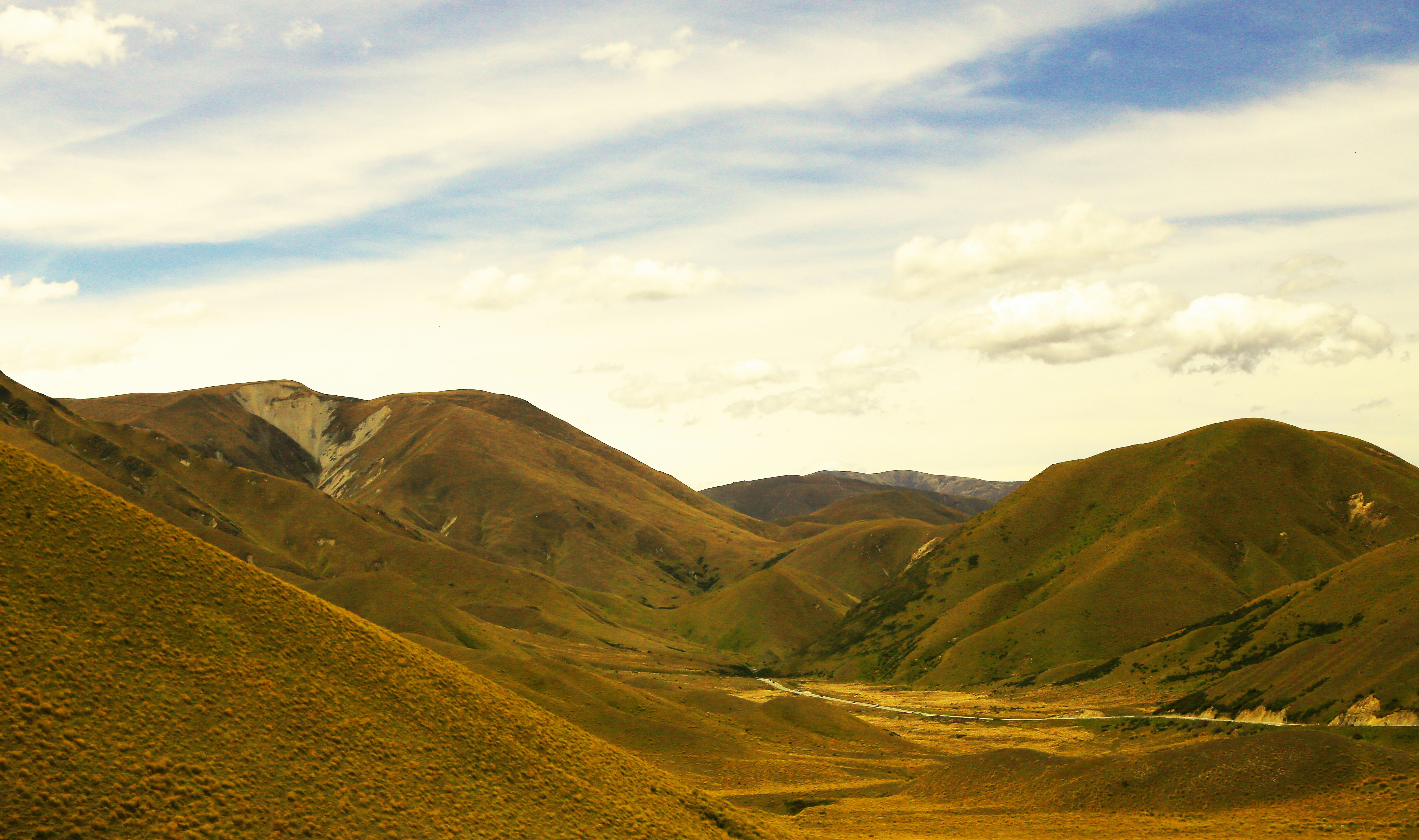 green mountains under white clouds during daytime