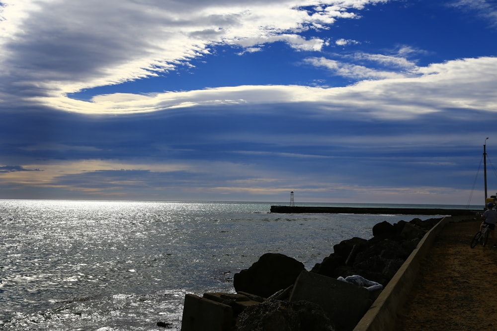 white and black ship on sea under blue sky during daytime